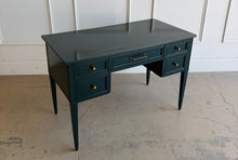 Load image into Gallery viewer, This beautifully refinished vintage desk offers timeless design with a fresh, designer-inspired finish. Professionally lacquered in Sherwin-Williams Rookwood Sash Green in a high-gloss sheen, it makes a bold yet sophisticated statement while preserving its classic mid-century silhouette. Five spacious drawers provide practical storage for office essentials, and the new antiqued brass hardware adds warmth and elegance against the rich green lacquer. Good Bones Furniture