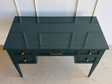 Load image into Gallery viewer, This beautifully refinished vintage desk offers timeless design with a fresh, designer-inspired finish. Professionally lacquered in Sherwin-Williams Rookwood Sash Green in a high-gloss sheen, it makes a bold yet sophisticated statement while preserving its classic mid-century silhouette. Five spacious drawers provide practical storage for office essentials, and the new antiqued brass hardware adds warmth and elegance against the rich green lacquer. Good Bones Furniture