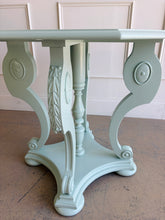 Load image into Gallery viewer, restored vintage foyer table. Professionally refinished in a custom mint green lacquer, this charming octagonal accent table pairs graceful neoclassical styling with a crisp contemporary finish. The sculptural pedestal base features scrolling supports, carved acanthus leaf details, and turned center elements that create visual interest from every angle. Good Bones Furniture