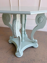 Load image into Gallery viewer, restored vintage foyer table. Professionally refinished in a custom mint green lacquer, this charming octagonal accent table pairs graceful neoclassical styling with a crisp contemporary finish. The sculptural pedestal base features scrolling supports, carved acanthus leaf details, and turned center elements that create visual interest from every angle. Good Bones Furniture
