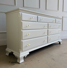 Load image into Gallery viewer, This vintage dresser by National Mt. Airy combines traditional craftsmanship with a fresh, updated finish. The silhouette is classic and balanced, with softly shaped feet, subtle crown molding, and clean paneled drawer fronts that give the piece a tailored, timeless presence. Professionally lacquered in a custom greige, the finish brings a versatile neutral tone that feels warm, refined, and easy to place in a range of interiors. Good Bones Furniture