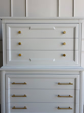Load image into Gallery viewer, This vintage Thomasville chest on chest provides generous storage within a tall, space-conscious silhouette. Professionally lacquered in Benjamin Moore White Dove, its softly warm off-white finish has subtle creamy undertones that feel bright without appearing stark. Six spacious drawers are arranged across two architecturally framed sections, creating the appearance of stacked chests. New brass knobs and linear pulls. Good Bones Furniture