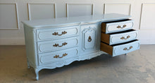 Load image into Gallery viewer, This vintage Thomasville dresser has been professionally lacquered in Farrow & Ball Parma Gray, a soft blue-gray finish that gives its French Provincial styling a fresh, updated look. The piece features a serpentine front, cabriole legs, ornate carved detailing, and original patinaed hardware that adds warmth and character. Good Bones Furniture