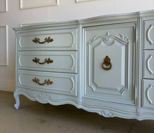 Load image into Gallery viewer, This vintage Thomasville dresser has been professionally lacquered in Farrow & Ball Parma Gray, a soft blue-gray finish that gives its French Provincial styling a fresh, updated look. The piece features a serpentine front, cabriole legs, ornate carved detailing, and original patinaed hardware that adds warmth and character. Good Bones Furniture