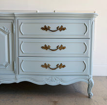 Load image into Gallery viewer, This vintage Thomasville dresser has been professionally lacquered in Farrow & Ball Parma Gray, a soft blue-gray finish that gives its French Provincial styling a fresh, updated look. The piece features a serpentine front, cabriole legs, ornate carved detailing, and original patinaed hardware that adds warmth and character. Good Bones Furniture