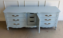 Load image into Gallery viewer, This vintage Thomasville dresser has been professionally lacquered in Farrow & Ball Parma Gray, a soft blue-gray finish that gives its French Provincial styling a fresh, updated look. The piece features a serpentine front, cabriole legs, ornate carved detailing, and original patinaed hardware that adds warmth and character. Good Bones Furniture
