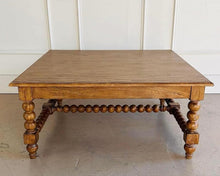 Load image into Gallery viewer, The Wellmington Coffee Table is a beautiful statement piece that brings both character and functionality to any living space. Crafted from solid Mango wood, it features stunning large bobbin legs and cross braces that highlight its traditional craftsmanship. The substantial square design ensures ample surface area, making it perfect for both decorative displays and everyday use. Good Bones Furniture