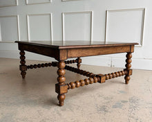 Load image into Gallery viewer, The Wellmington Coffee Table is a beautiful statement piece that brings both character and functionality to any living space. Crafted from solid Mango wood, it features stunning large bobbin legs and cross braces that highlight its traditional craftsmanship. The substantial square design ensures ample surface area, making it perfect for both decorative displays and everyday use. Good Bones Furniture