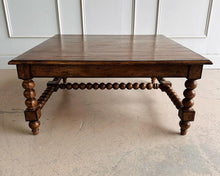 Load image into Gallery viewer, The Wellmington Coffee Table is a beautiful statement piece that brings both character and functionality to any living space. Crafted from solid Mango wood, it features stunning large bobbin legs and cross braces that highlight its traditional craftsmanship. The substantial square design ensures ample surface area, making it perfect for both decorative displays and everyday use. Good Bones Furniture