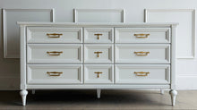 Load image into Gallery viewer, This vintage 7 drawer dresser by White Furniture Co. pairs quality construction with a clean, updated finish. Lacquered in Benjamin Moore White Dove, the soft creamy white highlights the layered drawer molding and tapered turned legs. The original hardware has been painted gold. Good Bones Furniture