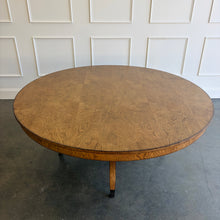 Load image into Gallery viewer, The Williamsburg Dining Table combines dramatic wood grain with a graceful, sculptural base. Crafted from mahogany solids, its expansive round top is available in your choice of richly figured burled ash or cerejeira veneer. Carefully arranged veneer panels create movement across the tabletop, while the substantial veneered apron adds visual depth. Four sweeping legs extend from the central pedestal and terminate in brass-capped feet. Good Bones Furniture