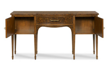Load image into Gallery viewer, Inspired by elegant 18th-century English furniture, the Henley Serving Console by Woodbridge Furniture blends timeless craftsmanship with sophisticated materials. Rich amboyna burl veneers adorn the top, drawer front, doors, and side panels, creating dramatic movement and depth that immediately captures attention. Ebony string inlay and finely figured cherry veneers frame the burl panels, highlighting the exceptional attention to detail throughout. Good Bones Furniture