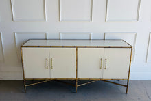 Load image into Gallery viewer, Ambella Home showroom sample cabinet with faux bamboo metal frame, linen finish doors, and satin brass hardware, inspired by 1950s Palm Beach chinoiserie style.