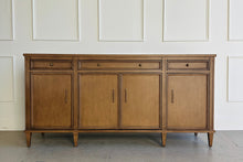 Load image into Gallery viewer, Avalaire Sideboard in Honey Chestnut by Good Bones Furniture, crafted from solid mahogany and mahogany veneers with four paneled doors, tapered legs, and clean architectural lines.