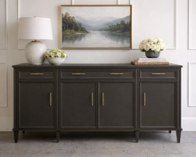 Load image into Gallery viewer, Avalaire Sideboard in Sherwin-Williams Urbane Bronze styled with artwork and a lamp, emphasizing the sideboard’s architectural form and understated elegance by Good Bones Furniture.
