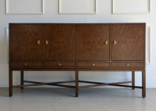 Load image into Gallery viewer, Basil Sideboard in dramatic bookmatched walnut burl with sculptural ginkgo leaf brass hardware and tall legs with X-stretchers, available from Good Bones Furniture.