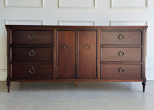 Load image into Gallery viewer, Boylan 9 drawer credenza dresser with all drawers and cabinet doors closed, finished in dark walnut with crotch mahogany veneer.