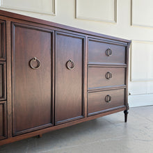 Load image into Gallery viewer, Angled right detail of the Boylan 9 drawer credenza dresser highlighting framed drawer fronts and patina brass ring pulls.