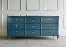 Load image into Gallery viewer, Boylan 9-drawer dresser in Rain Cloud, crafted from solid mahogany and mahogany veneers, featuring soft-close drawers and brass ring pulls