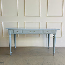 Load image into Gallery viewer, Front view of a vintage Ethan Allen writing desk refinished in Dockside Blue lacquer, showcasing balanced proportions, three drawers with lucite and brass pulls, and timeless traditional detailing.