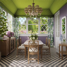 Load image into Gallery viewer, Grosvenor butterfly oval extension dining table styled in a dining room setting, showcasing its solid wood construction and expandable oval design.