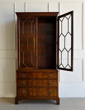 Load image into Gallery viewer, A true heirloom piece from Hickory Chair, this cabinet showcases everything that defines high-end traditional furniture—exceptional materials, precise craftsmanship, and timeless design. The case is wrapped in beautifully bookmatched crotch mahogany veneer, creating dramatic movement across the drawer fronts, while the glazed doors feature geometric muntins that give the piece a tailored, architectural feel. Good Bones Furniture