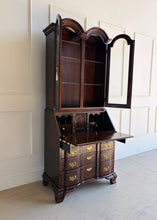 Load image into Gallery viewer, Vintage Hooker secretary with upper glass doors open, showcasing illuminated interior and glass shelves for books, barware, or display pieces.