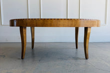 Load image into Gallery viewer, Side profile of Lillian August oval wood coffee table highlighting its gently tapered legs, balanced proportions, and refined transitional design.