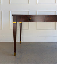 Load image into Gallery viewer, Straight-on close-up of the left side of the Theodore Alexander Bradbury Desk highlighting khaya swirl wood grain, brass ferrule detailing, and Cambridge finish at Good Bones Furniture in Raleigh, NC.