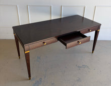 Load image into Gallery viewer, Wide 45-degree downward angled right view of the Theodore Alexander Bradbury Desk with center drawer open, revealing solid wood drawer construction and refined brass detailing at Good Bones Furniture in Raleigh, NC.