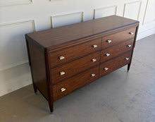 Load image into Gallery viewer, Front angled view from above of the Theodore Alexander Dorchester Dresser, emphasizing the Mayfair walnut finish, stepped case profile, and balanced proportions, photographed at Good Bones Furniture in Raleigh, North Carolina.