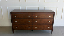 Load image into Gallery viewer, Front view of the Theodore Alexander Dorchester Dresser in figured walnut with Mayfair finish, featuring six drawers, stepped Art Origins detailing, and tapered legs, photographed at Good Bones Furniture in Raleigh, North Carolina.