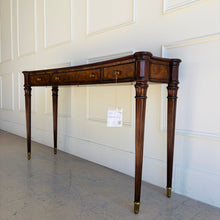 Load image into Gallery viewer, Angled elevation of the Theodore Alexander Grandinson Console showcasing its long, slender profile, balanced proportions, and traditional craftsmanship with brass details.