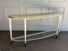 Load image into Gallery viewer, Angled right full view of the Judith Leiber console by Theodore Alexander featuring a demi-lune silhouette, white lacquer frame, pearl effect top, and brass accents