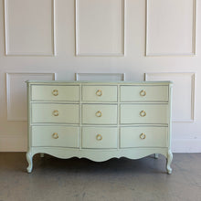 Load image into Gallery viewer, Vintage French dresser with a painted green finish, curved drawer fronts, and brass ring pull hardware.
