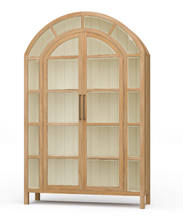 Load image into Gallery viewer, The Vannes 2 Door Display Cabinet from Bramble combines architectural scale with warm natural materials, creating a statement piece designed for both storage and display. Crafted from solid mahogany, the cabinet features a dramatic arched silhouette with glass-paneled doors framed in a rich contrasting finish that highlights the craftsmanship and curvature of the design. Good Bones Furniture
