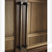 Load image into Gallery viewer, The Vannes 2 Door Display Cabinet from Bramble combines architectural scale with warm natural materials, creating a statement piece designed for both storage and display. Crafted from solid mahogany, the cabinet features a dramatic arched silhouette with glass-paneled doors framed in a rich contrasting finish that highlights the craftsmanship and curvature of the design. Good Bones Furniture
