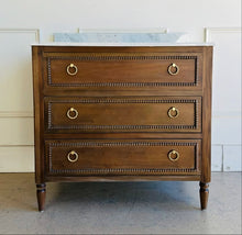 Load image into Gallery viewer, Upgrade your space with this stunning Bramble Cholet single bathroom vanity, where classic design meets modern functionality. Crafted from solid mahogany in a variety of finishes, this piece brings warmth and timeless beauty to any bathroom.
Topped with luxurious marble, with a white American Standard undermount sink. Good Bones Furniture
