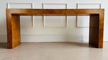 Load image into Gallery viewer, Make a statement with the bold beauty of the Burlwood Console Table. Featuring a sleek, continuous silhouette and book-matched burl veneer, this piece delivers luxurious texture and refined modernism in one dramatic package. Good Bones Furniture
