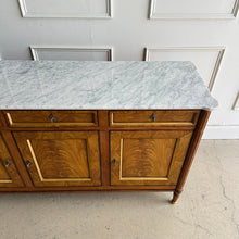 Load image into Gallery viewer,  A study in balance and material, the Riley Sideboard draws from European neoclassical design—most notably Louis XVI—reimagined through a quieter, more modern lens. The form is clean and architectural, defined by symmetry, framed panels, and gently tapered legs that give the piece a sense of structure without excess. Cerejeira veneers are carefully bookmatched across each door, revealing a striking cathedral grain that brings movement and depth to the façade. Good Bones Furniture
