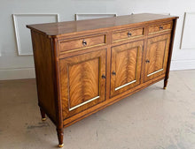 Load image into Gallery viewer,  A study in balance and material, the Riley Sideboard draws from European neoclassical design—most notably Louis XVI—reimagined through a quieter, more modern lens. The form is clean and architectural, defined by symmetry, framed panels, and gently tapered legs that give the piece a sense of structure without excess. Cerejeira veneers are carefully bookmatched across each door, revealing a striking cathedral grain that brings movement and depth to the façade. Good Bones Furniture

