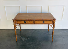 Load image into Gallery viewer, The new Dunehaven Bamboo Writing Desk brings the warmth and character of classic bamboo-inspired design to your home office, bedroom, or favorite writing corner. Its gently rounded trim, turned legs, and rich wood grain give the piece a collected, timeless feel, while two drawers keep papers and everyday essentials close at hand. Good Bones Furniture
