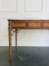 Load image into Gallery viewer, The new Dunehaven Bamboo Writing Desk brings the warmth and character of classic bamboo-inspired design to your home office, bedroom, or favorite writing corner. Its gently rounded trim, turned legs, and rich wood grain give the piece a collected, timeless feel, while two drawers keep papers and everyday essentials close at hand. Good Bones Furniture
