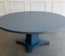 Load image into Gallery viewer, Inspired by Mid-Century design, the Maxwell Round Dining Table pairs clean architectural lines with softened curves for a look that feels modern yet timeless. Crafted from hand-selected oak solids and veneers, its generous 72-inch round top is supported by a substantial pedestal base with four gracefully curved feet. The table has been professionally lacquered by Good Bones Furniture in Farrow &amp; Ball Hague Blue.
