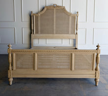 Load image into Gallery viewer, The Frontgate Beauvier French Cane Bed brings timeless Louis XVI style to the bedroom with elegant straight lines, classical ornament, and warm natural texture. Crafted from solid mahogany, it features handwoven double cane panels, twisted ribbon carving, floral swag and laurel wreath detailing, and beaded accents along the rails and finials. Good Bones Furniture
