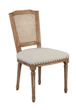 Load image into Gallery viewer, The Ellen Side Chair combines timeless European-inspired detailing with everyday durability. Crafted from solid mango wood, its distressed Beachwood finish highlights the carved frame, turned legs, and warm natural character of the wood. A handwoven cane back adds airy texture, while the upholstered seat is finished with classic nailhead trim. Sand Revolution Performance Fabric. Good Bones Furniture
