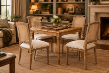 Load image into Gallery viewer, The Ellen Side Chair combines timeless European-inspired detailing with everyday durability. Crafted from solid mango wood, its distressed Beachwood finish highlights the carved frame, turned legs, and warm natural character of the wood. A handwoven cane back adds airy texture, while the upholstered seat is finished with classic nailhead trim. Sand Revolution Performance Fabric. Good Bones Furniture
