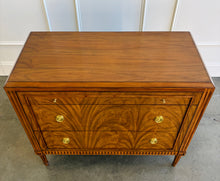 Load image into Gallery viewer, The Lipton 3 Drawer Chest brings classic European character. Crafted from mahogany solids with bookmatched cerejeira veneers, the drawer fronts showcase a dramatic cathedral grain that gives the piece warmth and movement. Fluted corner details, a carved lower border, tapered legs, and decorative brass hardware complete its tailored silhouette. Three spacious drawers on soft close glides. Good Bones Furniture
