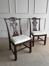 Load image into Gallery viewer, Classic craftsmanship never goes out of style. This exceptional set of eight Henredon Chippendale dining chairs showcases the artistry and quality that made Henredon one of America's premier furniture makers. Crafted from richly finished mahogany, each chair features an intricately carved pierced splat back inspired by 18th-century Chippendale designs, accented with elegant detailing and crisp architectural lines. Good Bones Furniture
