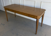 Load image into Gallery viewer, This Hickory White Home Office Desk is an open-box showroom sample with clean lines, tailored proportions, and a warm wood finish that brings a refined, classic presence to a workspace. The long rectangular top offers generous room for a laptop, writing materials, and everyday office essentials, while the slender fluted legs keep the silhouette light and elegant. Good Bones Furniture

